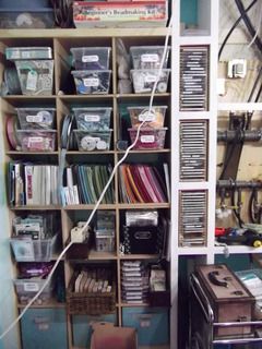 Still some wires to move and the control panel to be covered ... but we are getting there ! This is my cube storage ... ribbon totes, 8.5x11 papers, stamps in bins, and fabric & fibres in bins below. Up above I have the bigger things that I'll get to some day ... like the bead making kit !!